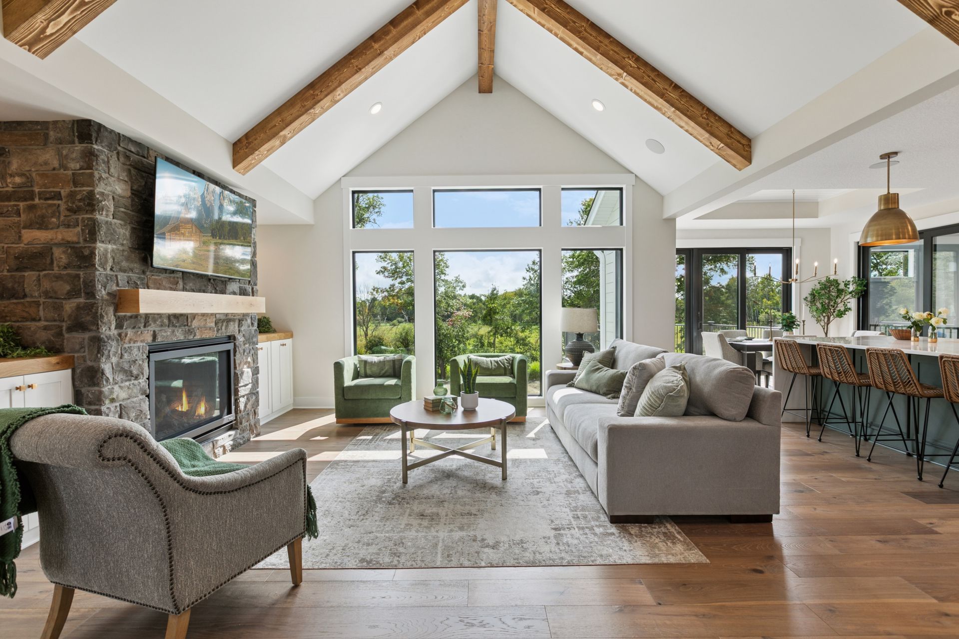 Floor-to-vault windows framing lush green outdoor views
