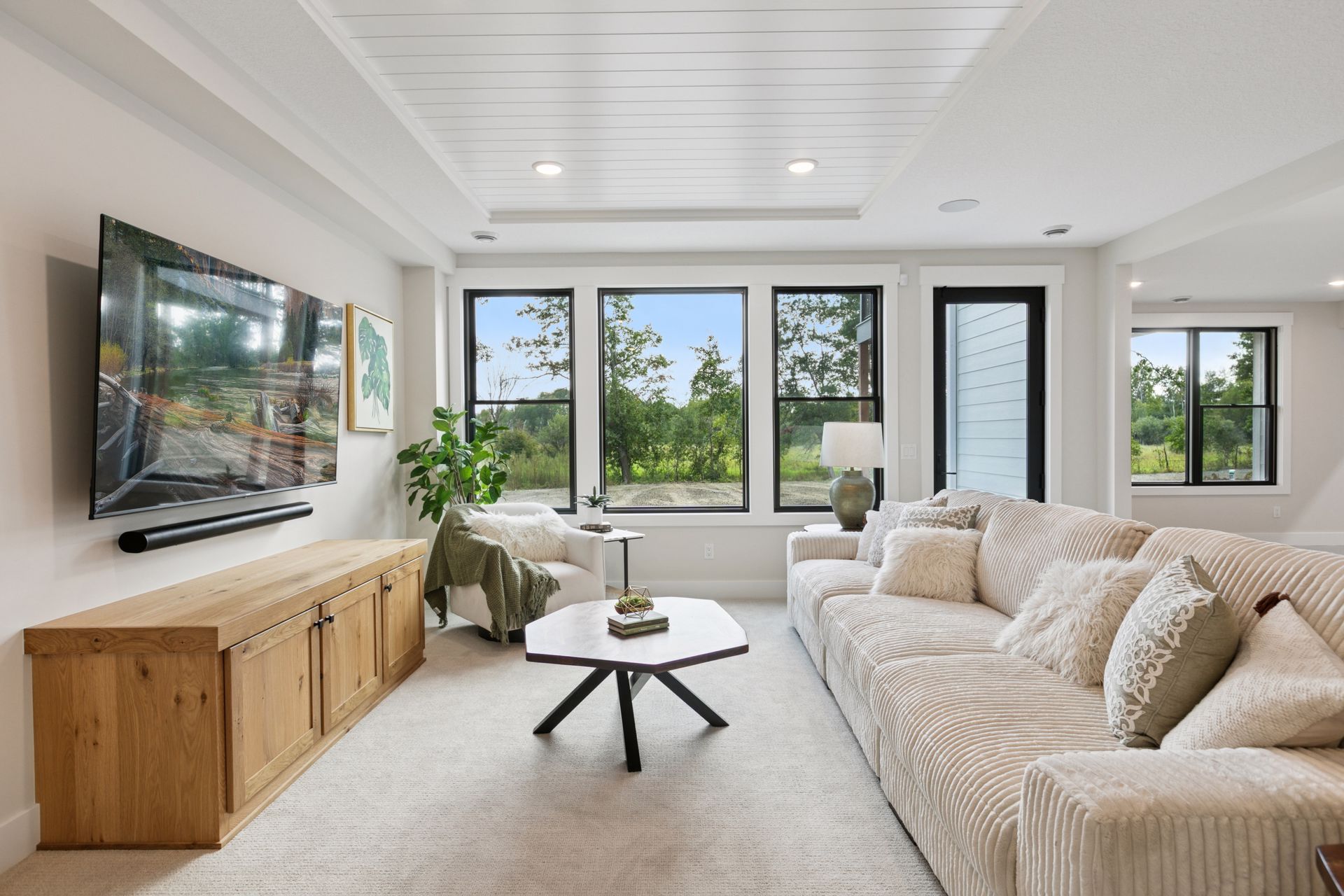 Lower-level rec room with vaulted shiplap ceiling