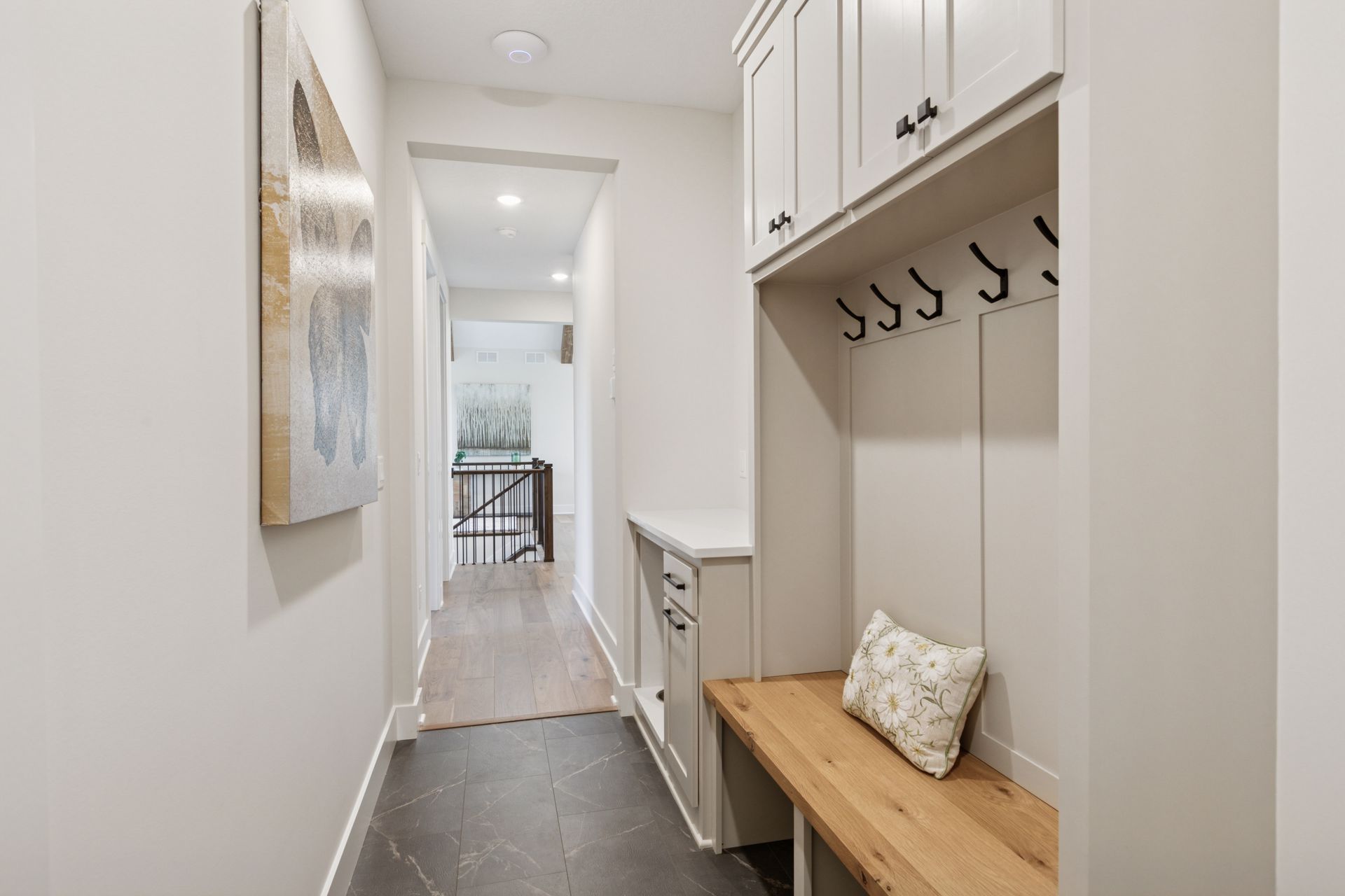 Entry mudroom with built-in storage, bench, and organized coat rack
