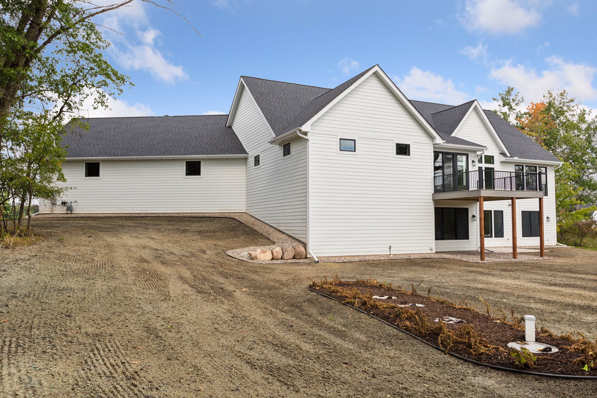 Landscaped side of home with gentle slope