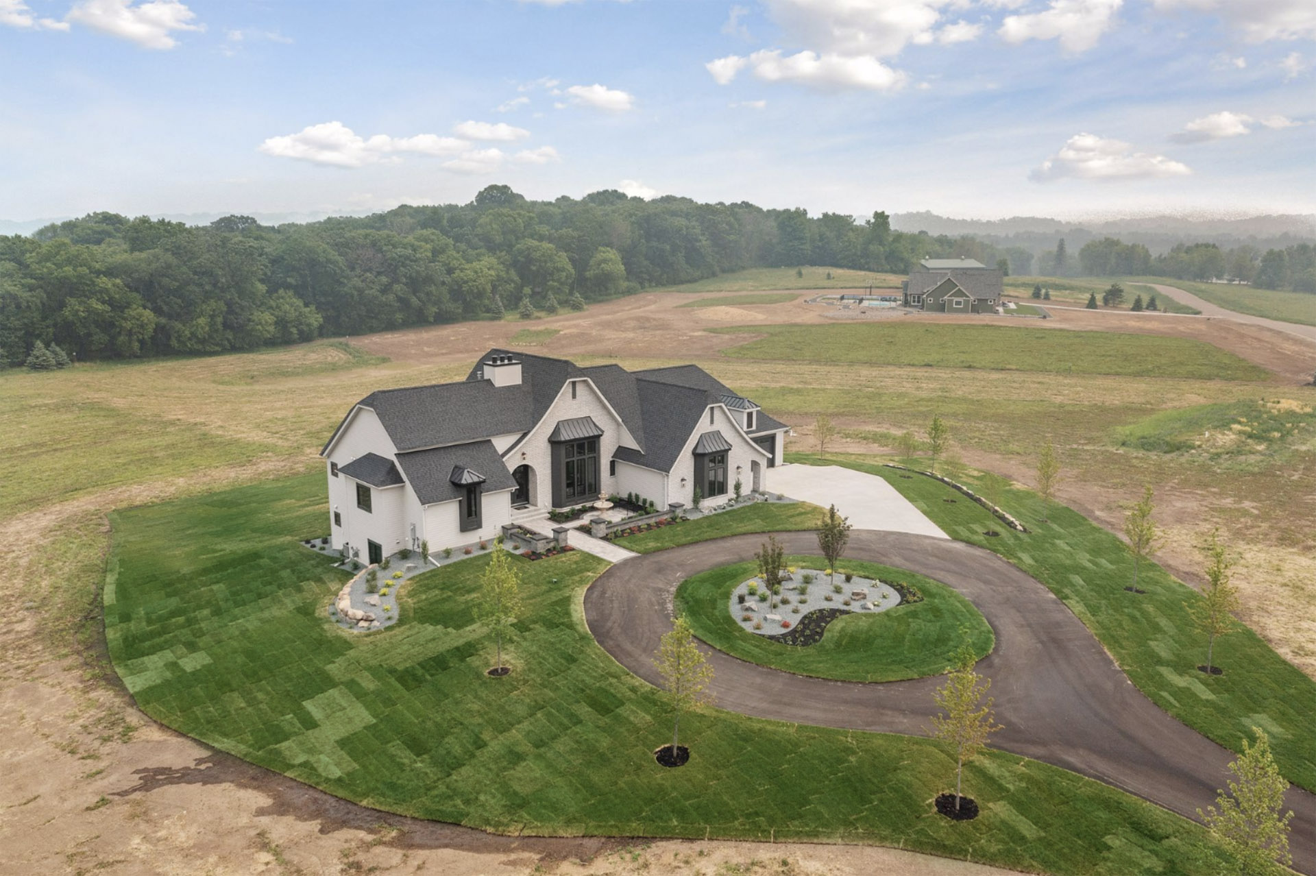 Considered one of the best lots and views in Afton Creek Preserve. Left side aerial view of luuxury home.