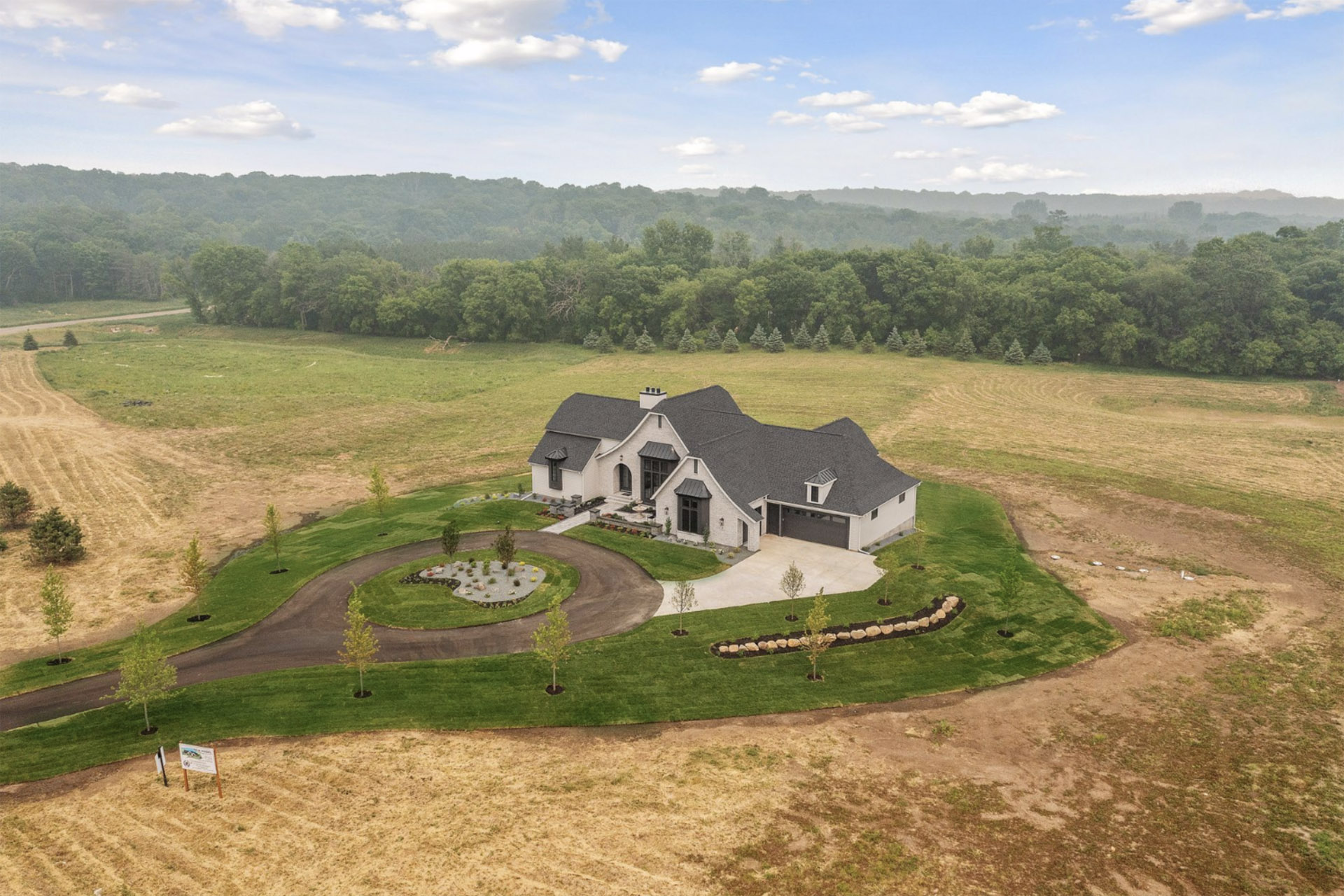 Beautiful Setting Minutes to Hudson, Woodbury, the Twin Cities, and More. Aerial view of luuxury home and lot