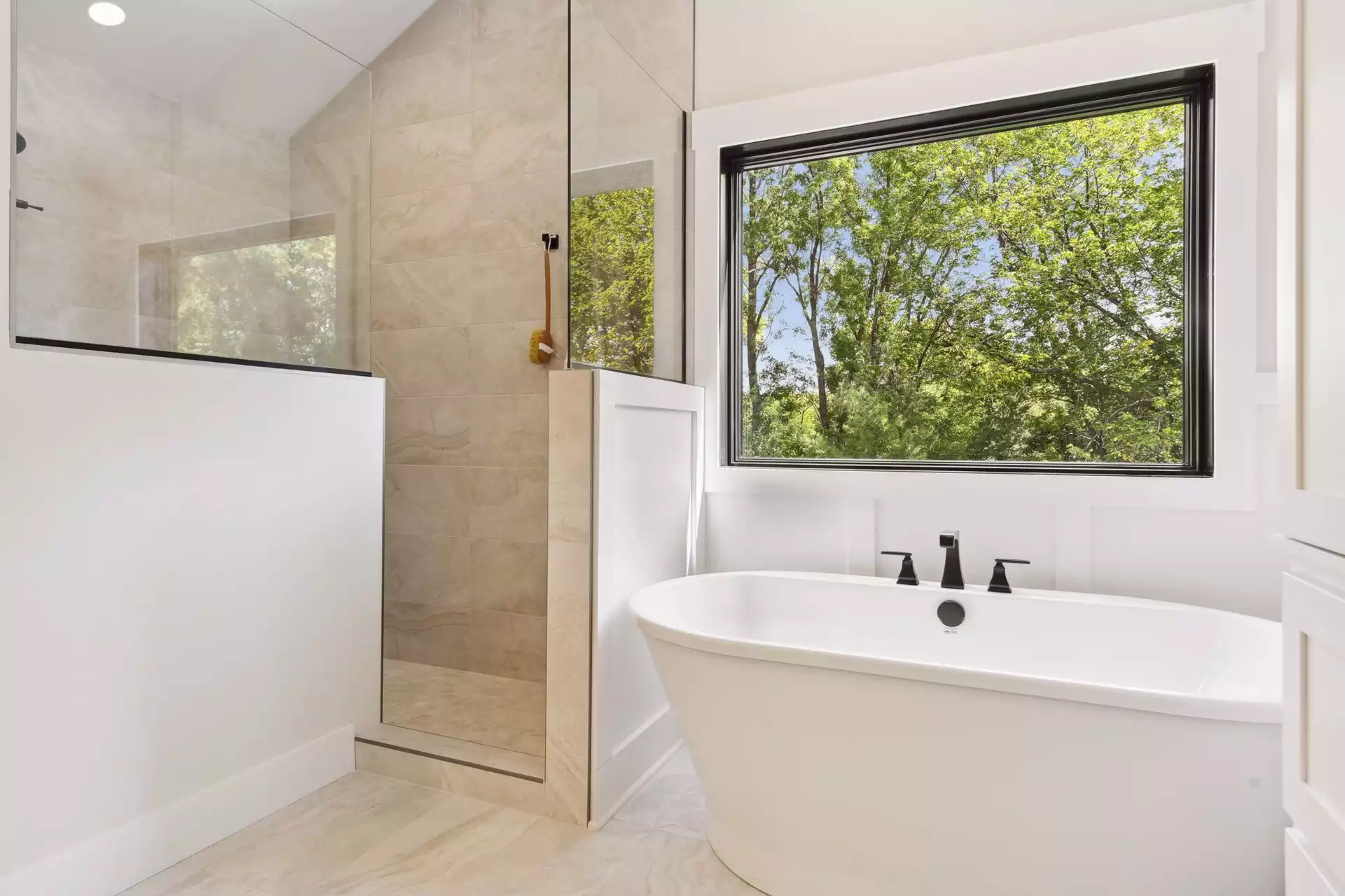Owner’s suite bathroom features walk-in glass shower