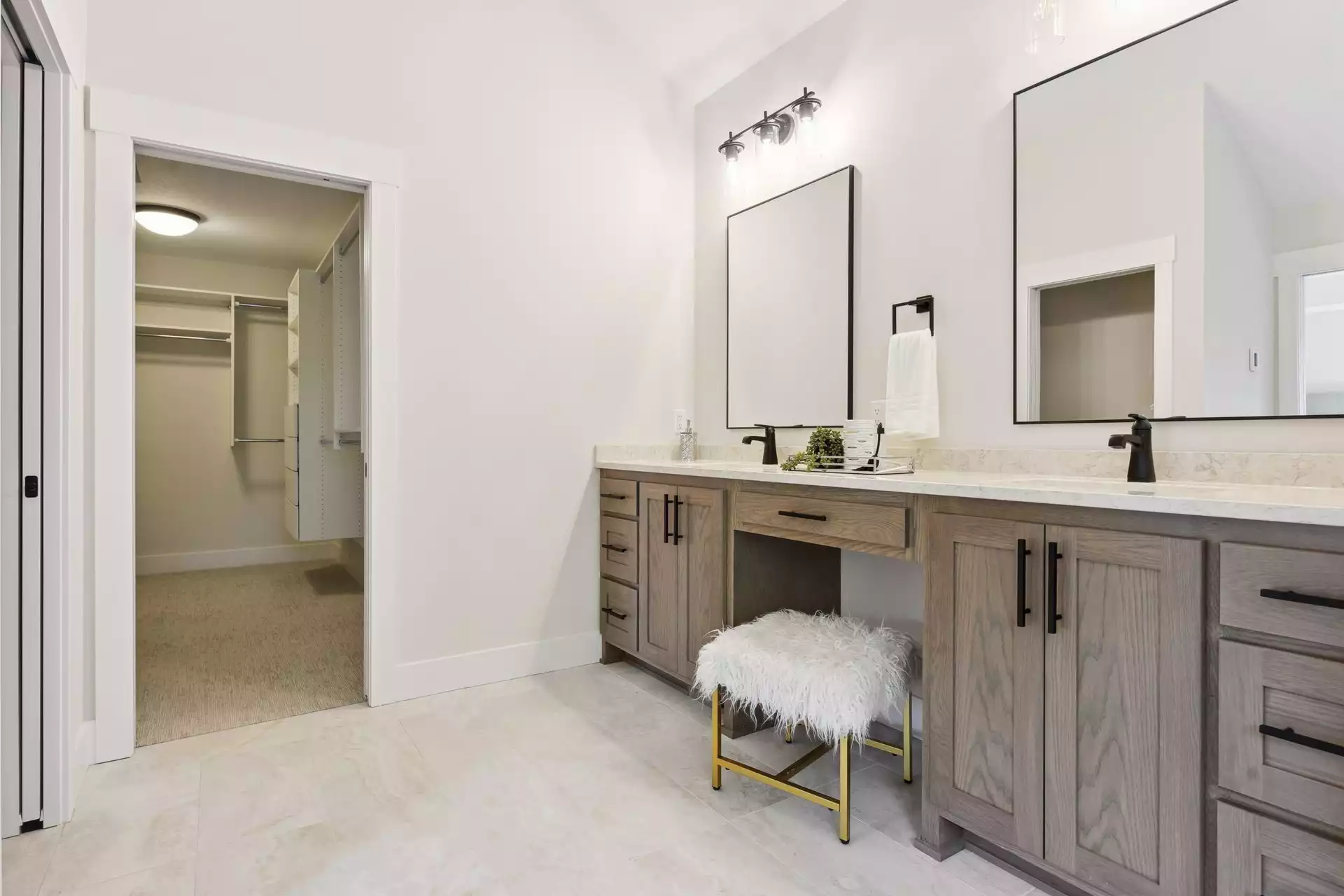 Owner’s suite bathroom features double vanity with make-up station